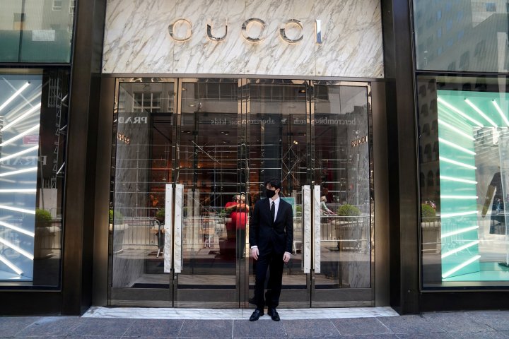 In pictures: An employee stands outside a Gucci store on the first day of the phase two re-opening of businesses following the outbreak of the coronavirus disease (COVID-19), in the Manhattan borough of New York City, New York, U.S., June 22, 2020. REUTERS/Carlo Allegri/File Photo