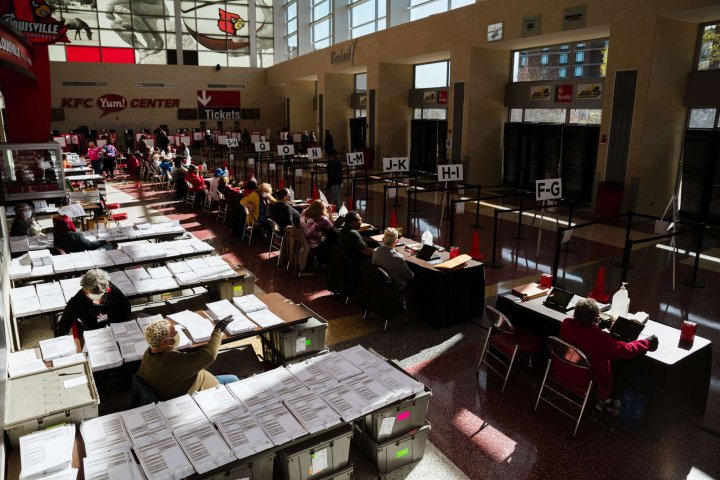 Election officials wait for voters in the polling area in the KFC YUM!