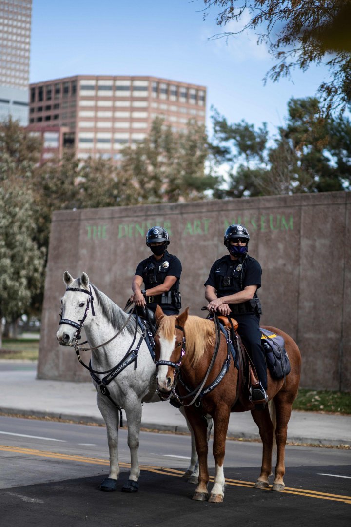 Police officers on horseback are seen outside of the Denver Elections Division building