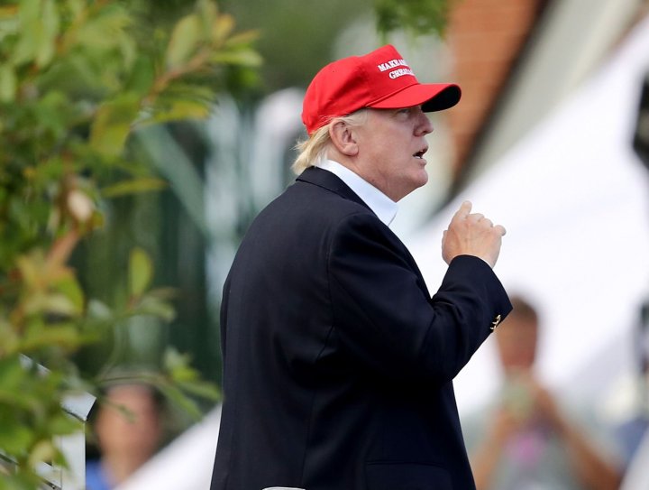 In this file photo US President Donald Trump waves as he leaves the U.S. Women's Open round three on July 15, 2017 at Trump National Golf Club in Bedminster, New Jersey. - As much as President Donald Trump loves golf, leaders of the sport are racing away from the embattled US leader for what they say is the good of the game. The PGA of America stripped the 2022 PGA Championship from Trump National at Bedminster, New Jersey, on January 10, days after Trump supporters attacked the US Capitol. (Photo by ELSA / GETTY IMAGES NORTH AMERICA / AFP)