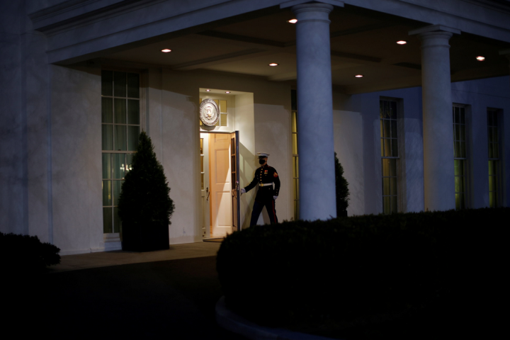A U.S. Marine opens a door of the West Wing door, an indication that U.S. President Donald Trump is in the Oval Office during his last day in office, in Washington U.S., January 19, 2021. REUTERS/Carlos Barria