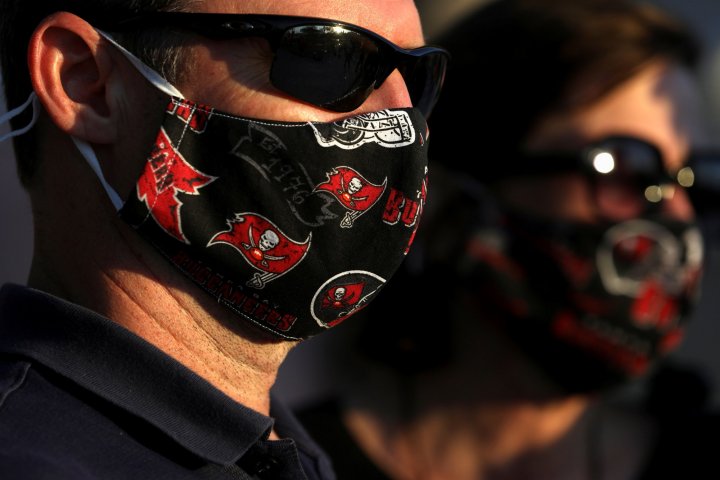 	Tampa Bay Buccaneers fans wore themed masks at the Super Bowl Experience presented by Lowe’s at Curtis Hixon Waterfront Park ahead of the weekend's Super Bowl LV between the Kansas City Chiefs and Tampa Bay Buccaneers in Tampa, Florida, U.S., February 5, 2021. REUTERS/Eve Edelheit