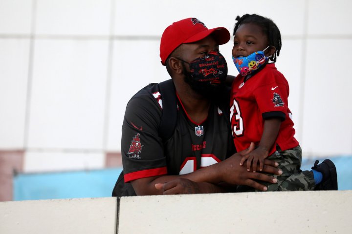 	Brandon Brown of Largo, Florida spends time with his son Cameron, 2 on the Tampa Riverwalk at the Super Bowl Experience presented by Lowe’s at Curtis Hixon Waterfront Park ahead of the weekend's Super Bowl LV between the Kansas City Chiefs and Tampa Bay Buccaneers in Tampa, Florida, U.S., February 5, 2021. REUTERS/Eve Edelheit
