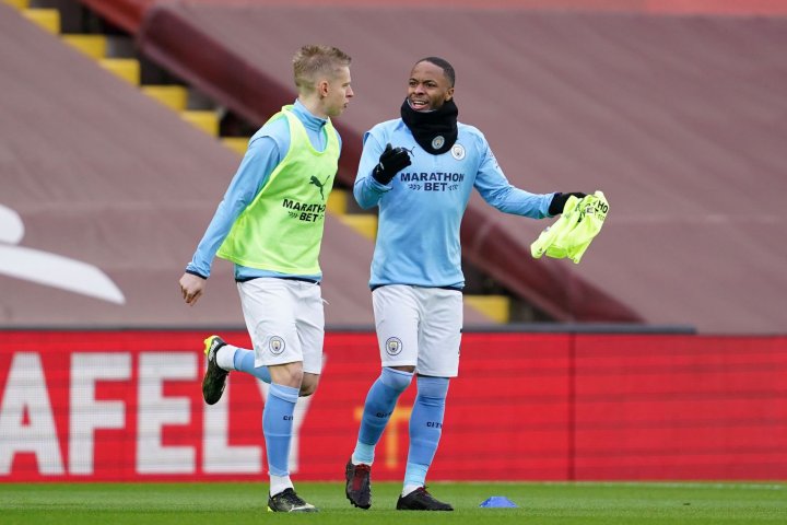 	Manchester City's Ukrainian midfielder Oleksandr Zinchenko (L) warms up with Manchester City's English midfielder Raheem Sterling ahead