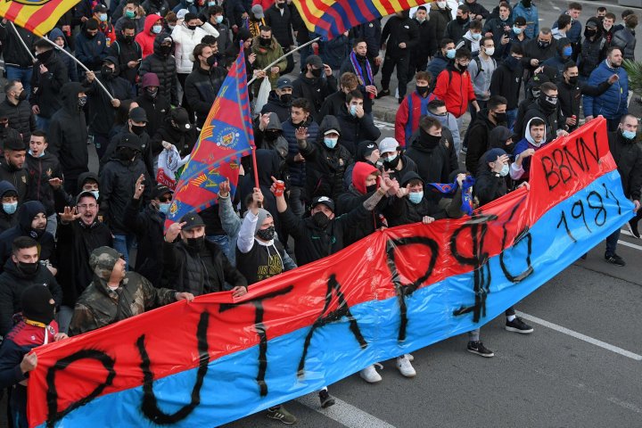 	FC Barcelona fans wave the club's flags as they march with a banner insulting PSG ahead of the