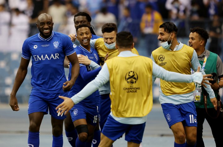 Saudi Arabia's Al Hilal soccer team players celebrate their trophy of the  AFC Champions League 2021 after the team beats South Korea's Pohang  Steelers 2-0 during their final soccermatch at the King