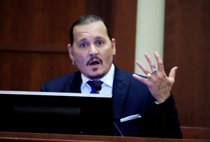 Actor Johnny Depp gestures as he testifies in the courtroom during the defamation trial against ex-wife Amber Heard at the Fairfax County Circuit Courthouse in Fairfax, Virginia, U.S., April 25, 2022. Steve Helber/Pool via REUTERS