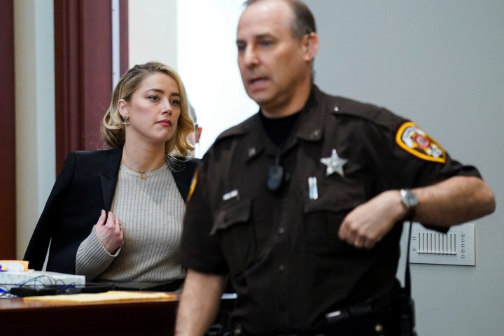 Actor Amber Heard returns from a break during the ex-husband Johnny Depp's defamation trial against her at the Fairfax County Circuit Courthouse in Fairfax, Virginia, U.S., May 18, 2022. REUTERS/Kevin Lamarque/Pool