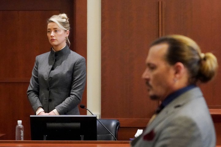 Actors Amber Heard and Johnny Depp watch as the jury leaves the courtroom at the end of the day at the Fairfax County Circuit Courthouse in Fairfax, Va., Monday, May 16, 2022. Steve Helber/Pool via REUTERS