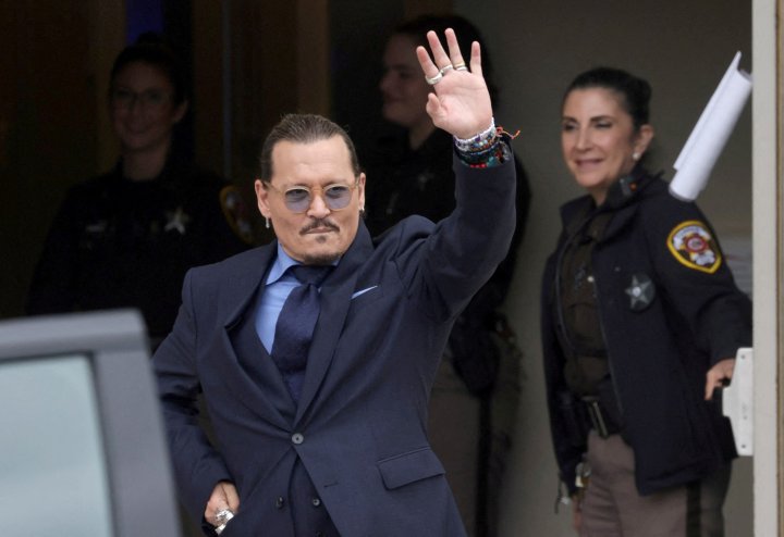 FILE PHOTO: Actor Johnny Depp gestures as he leaves the Fairfax County Circuit Courthouse following his defamation trial against his ex-wife Amber Heard, in Fairfax, Virginia, U.S., May 27, 2022. REUTERS/Evelyn Hockstein/File Photo