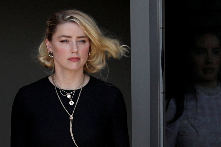 FILE PHOTO: Amber Heard leaves Fairfax County Circuit Courthouse after the jury announced split verdicts  in the Depp v. Heard civil defamation trial at the Fairfax County Circuit Courthouse in Fairfax, Virginia, U.S., June 1, 2022. REUTERS/Tom Brenner/File Photo