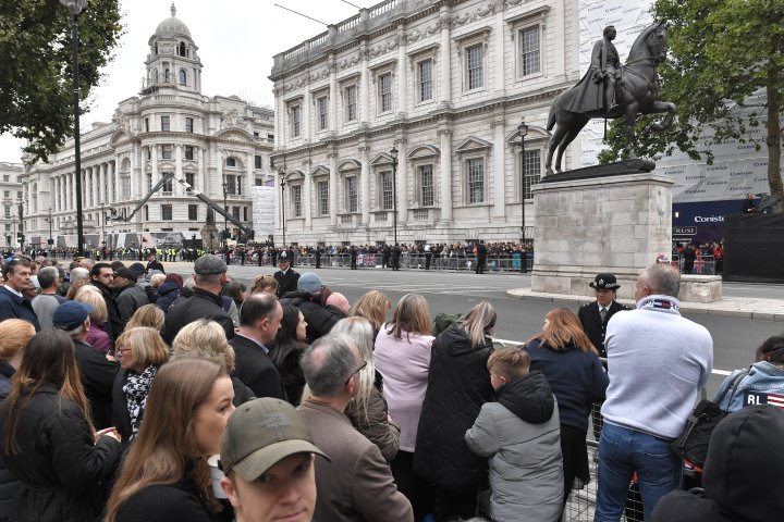 Gente en las calles de Londres esperan a que comience la procesión a pie