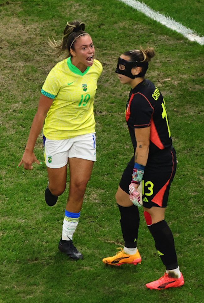 Priscila of Brazil laughs in Spanish keeper Coll's face
