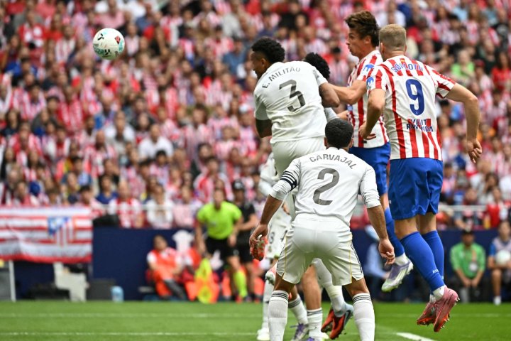 Atletico Madrid's Spanish defender #24 Robin Le Normand (C) heads the ball challenged by Rayo Vallecano's Spanish defender #03 Pep Chavarria (2L) and Rayo Vallecano's Dutch defender #33 Jozhua Vertrouwd during the Spanish league football match between Club Atletico de Madrid and Rayo Vallecano de Madrid at the Metropolitano stadium in Madrid on September 24, 2025. (Photo by Javier SORIANO / AFP)