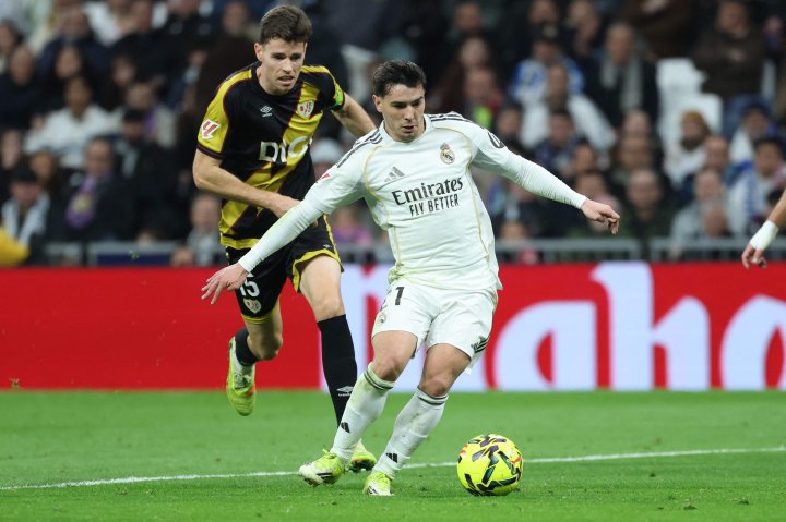 Soccer Football - LaLiga - Real Madrid v Rayo Vallecano - Santiago Bernabeu, Madrid, Spain - February 1, 2026 Rayo Vallecano's Ilias Akhomach and Real Madrid's Brahim Diaz clash REUTERS/Ana Beltran